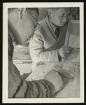 [Two adult males sketching/wood carving] by Unidentified